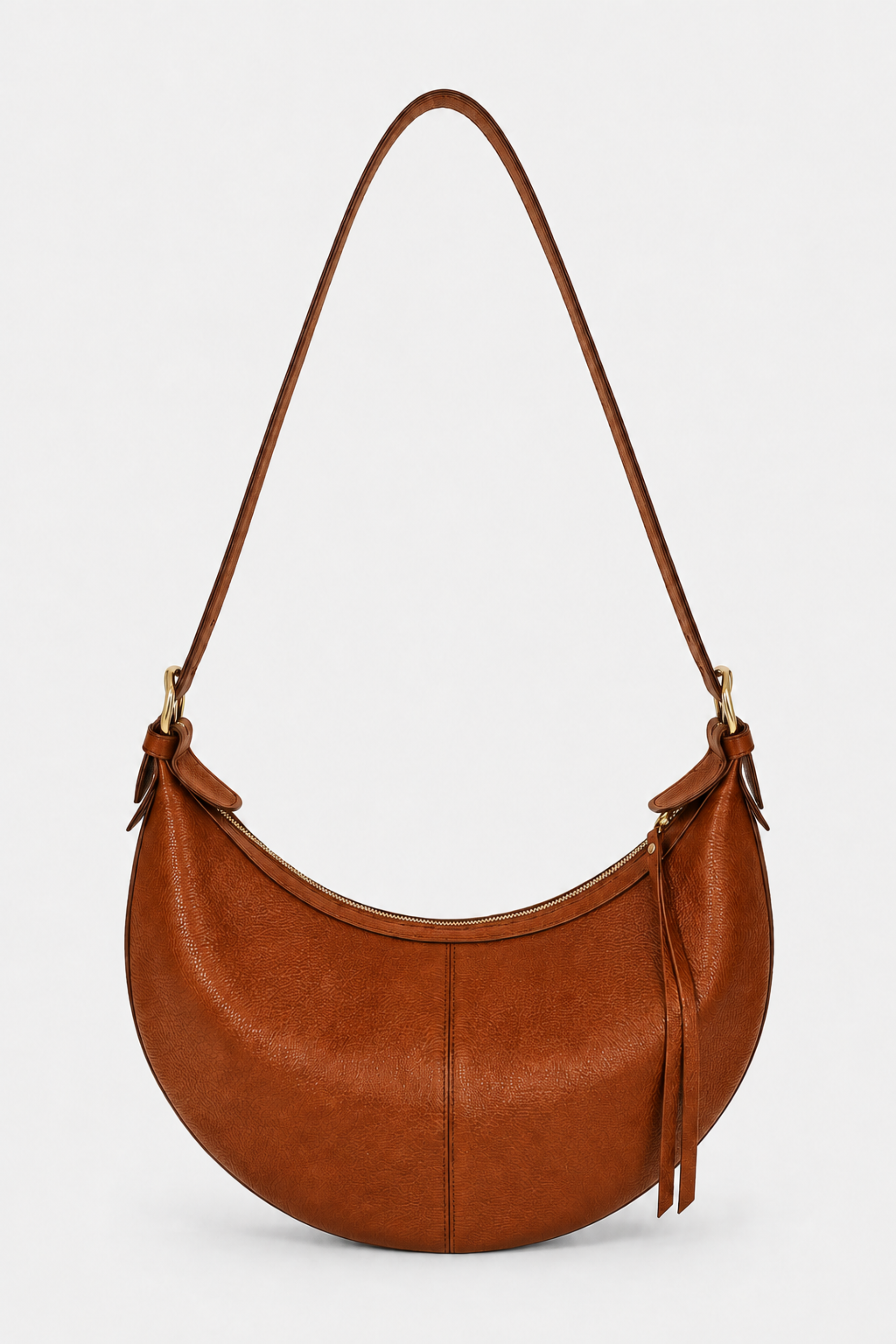 A crescent-shaped brown leather shoulder bag with an adjustable strap and gold buckle hardware 