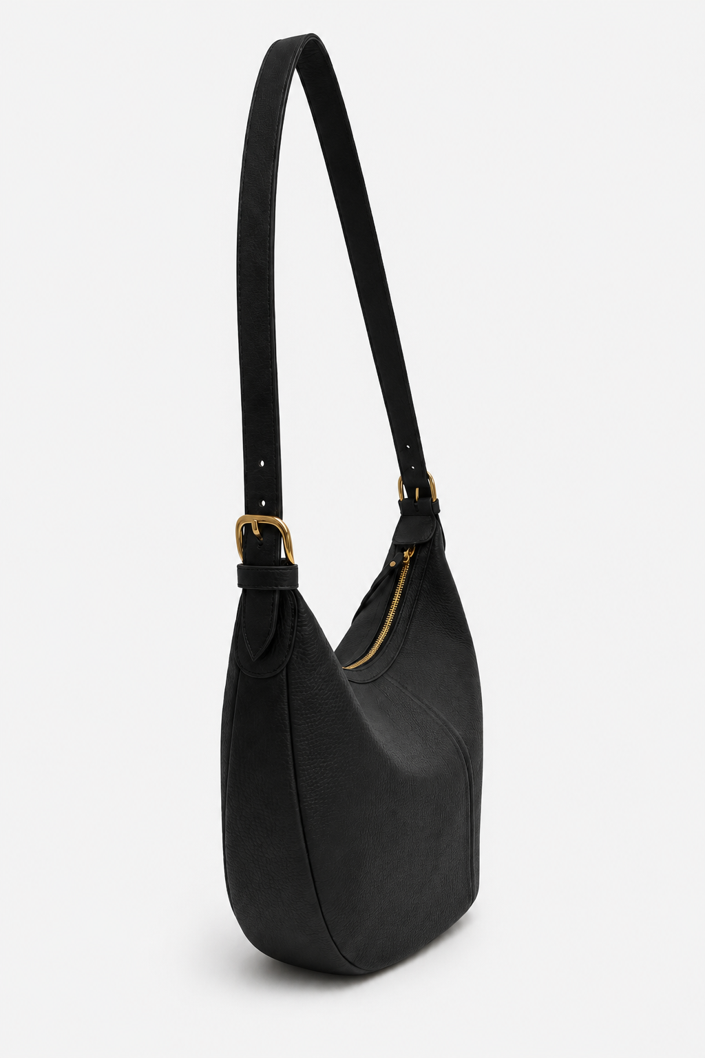A black slouchy full grain leather shoulder bag with an adjustable strap and gold-tone hardware, shown from the side view