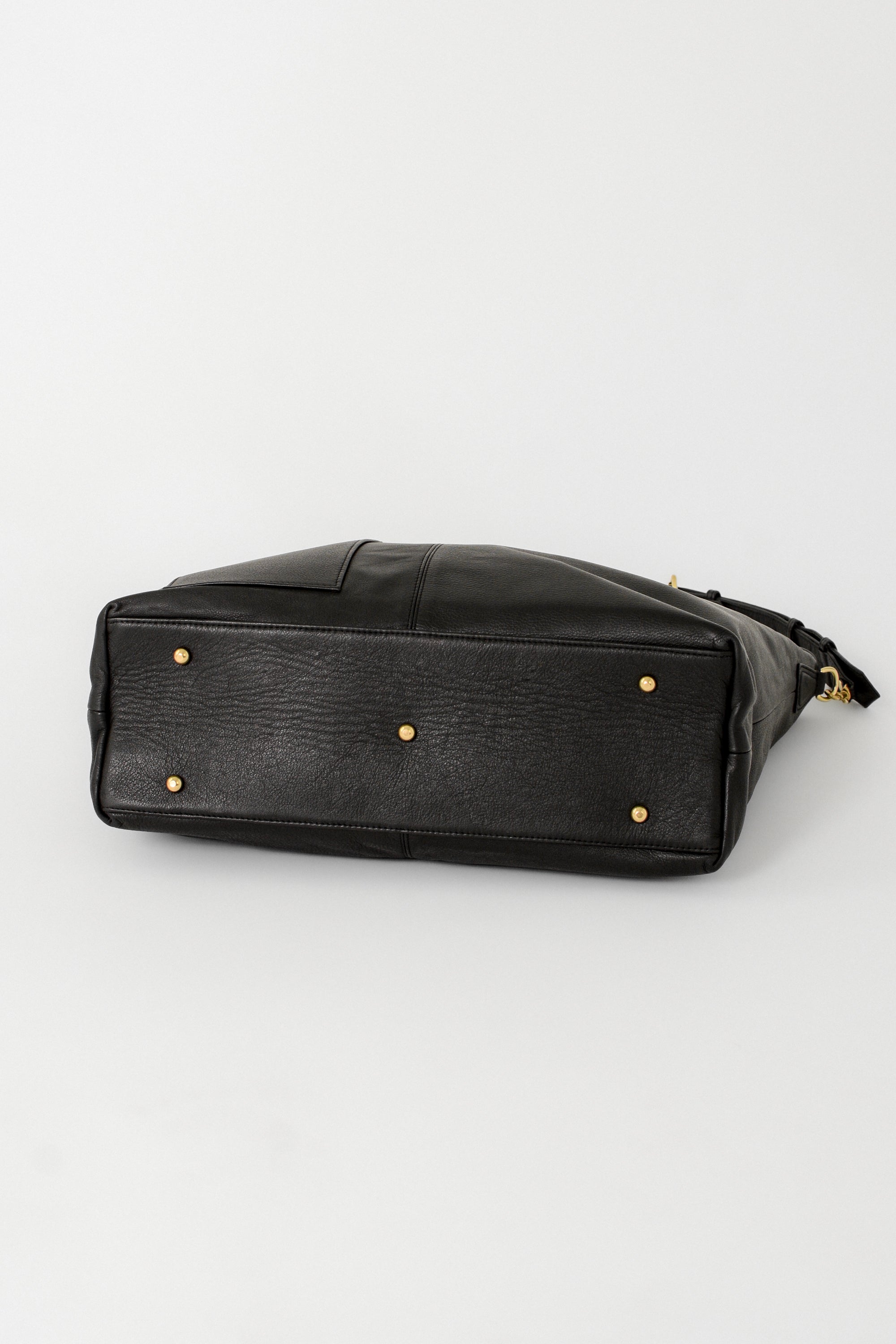 Black leather bag with gold solid brass feet on the bottom