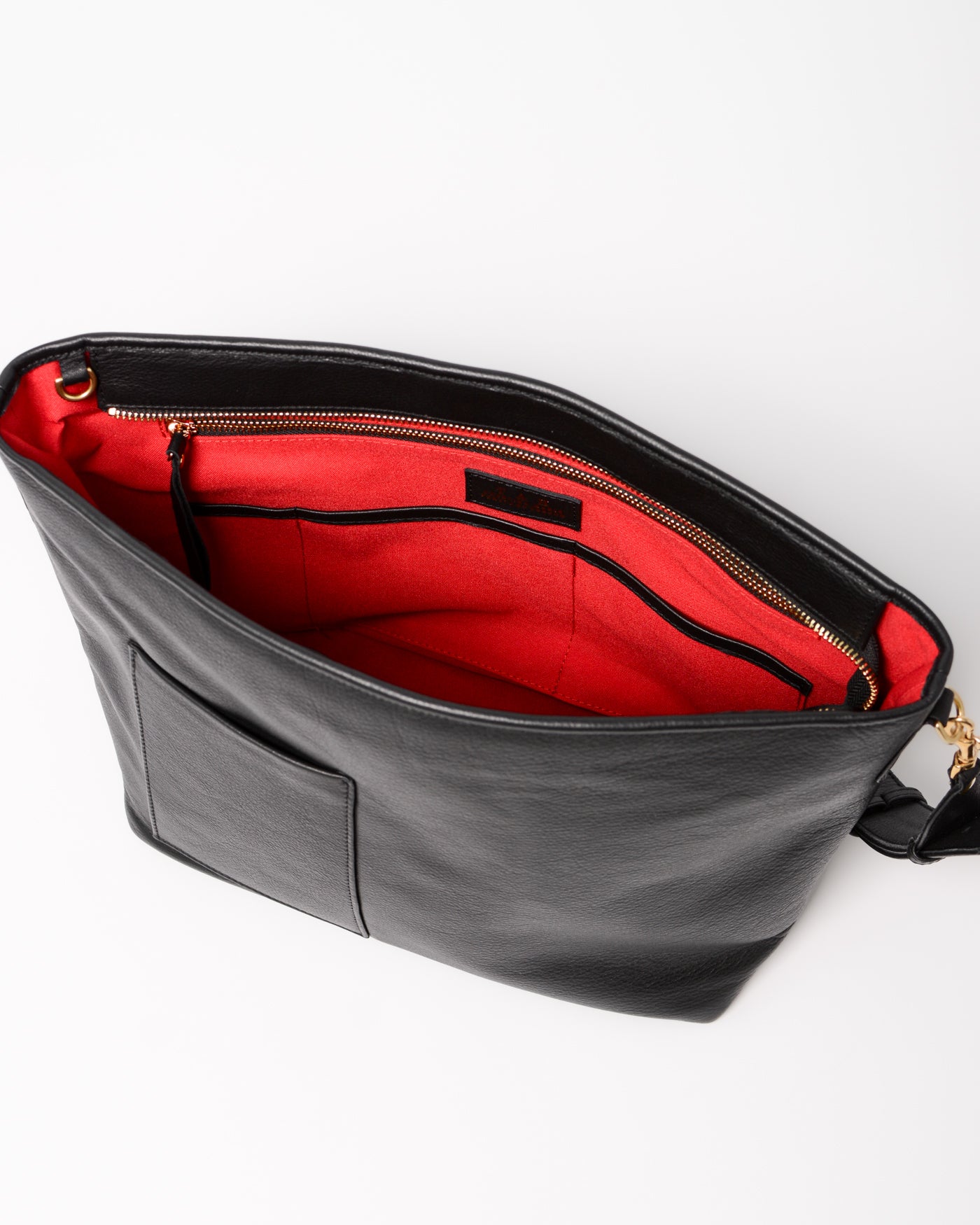 Charlee Tote in black full-grain leather with red lining and zipper closure. 
