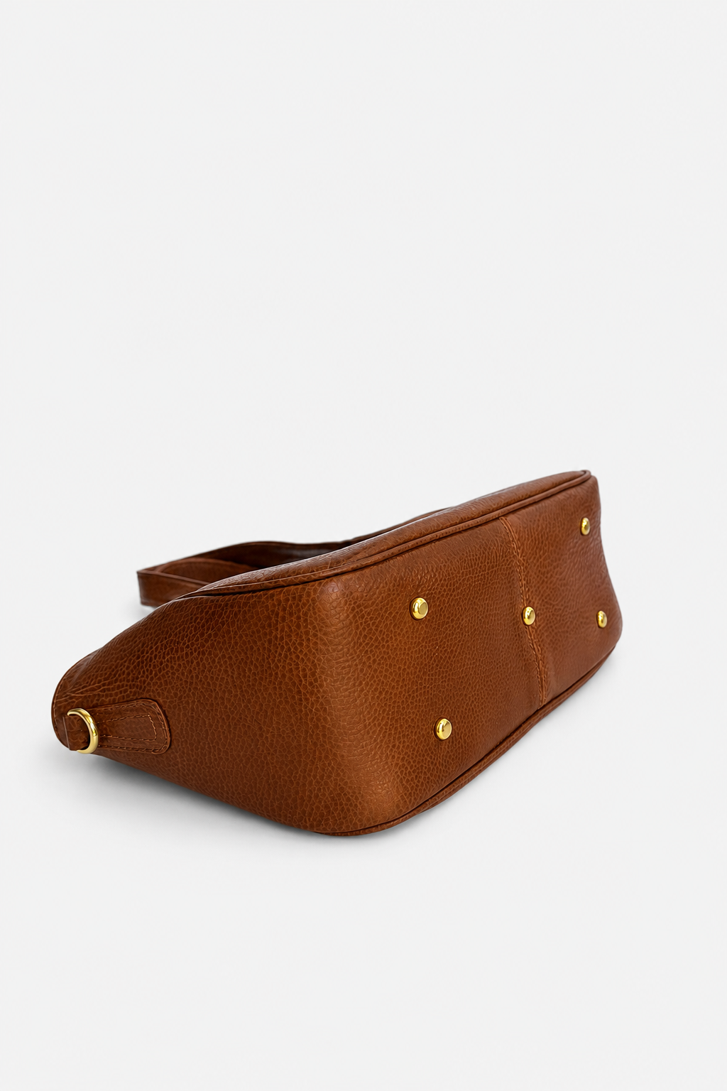 A brown textured leather belt bag with gold-tone metal feet, shown from a side angle on a light gray background.