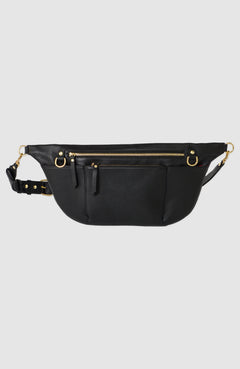 The TAH Commuter Fanny Pack in full-grain leather with solid brass hardware, three exterior zipper pockets, adjustable strap, and fully lined interior. Perfect for travel and everyday use.