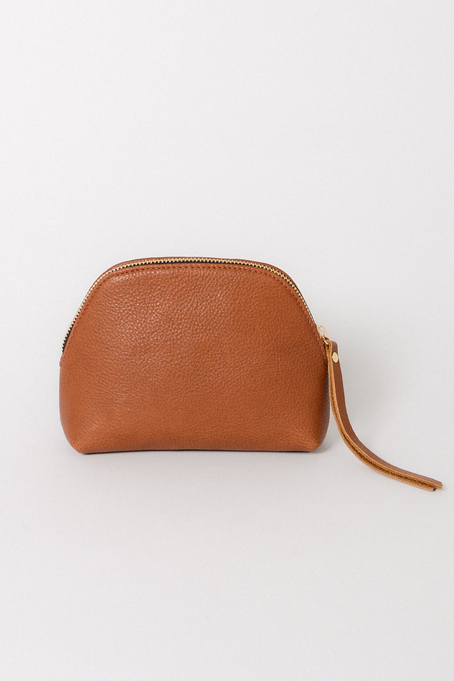 Leather cosmetic pouch in brown with a zipper closure and long leather zipper pull