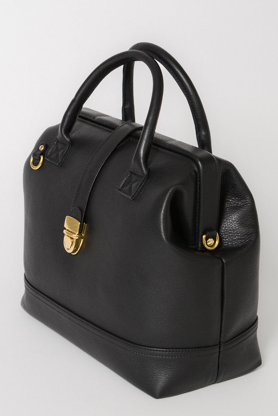 Handcrafted Full grain leather Doctor Bag with double handles, gold lock and metal frame opening. Gold hardware details and soft pebbled leather. 