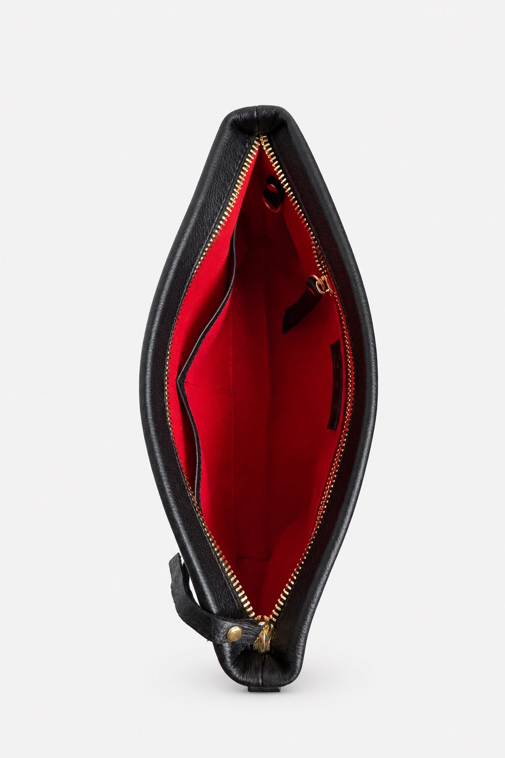 A black leather compact crossbody bag shown open from the front, revealing a bright red interior lining and gold-tone zipper hardware, set against a plain light gray background.