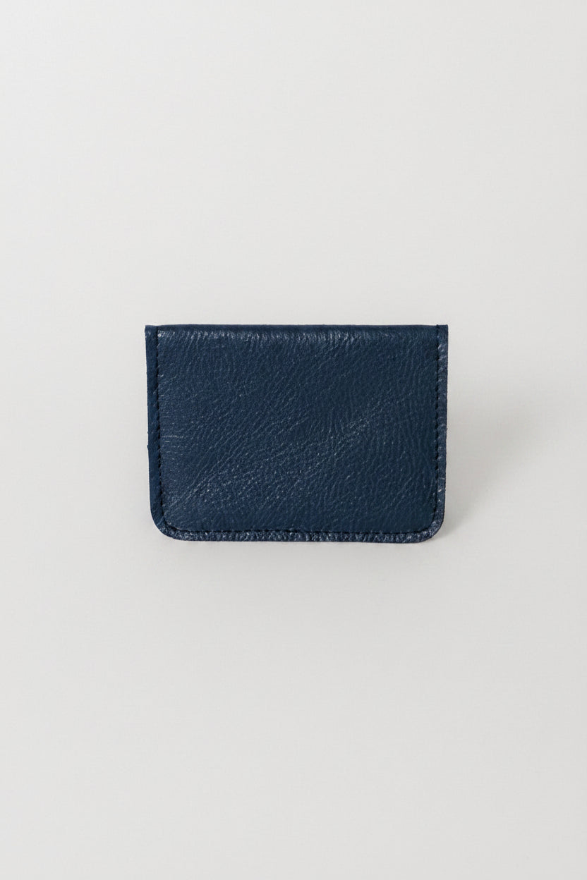 Fold over full grain leather wallet in the color marine blue, a simple sleek design that holds up to 10 credit cards, and some cash