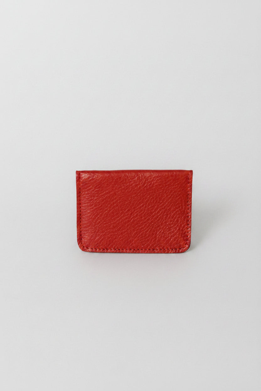 Fold over full grain leather wallet in the color red, a simple sleek design that holds up to 10 credit cards, and some cash