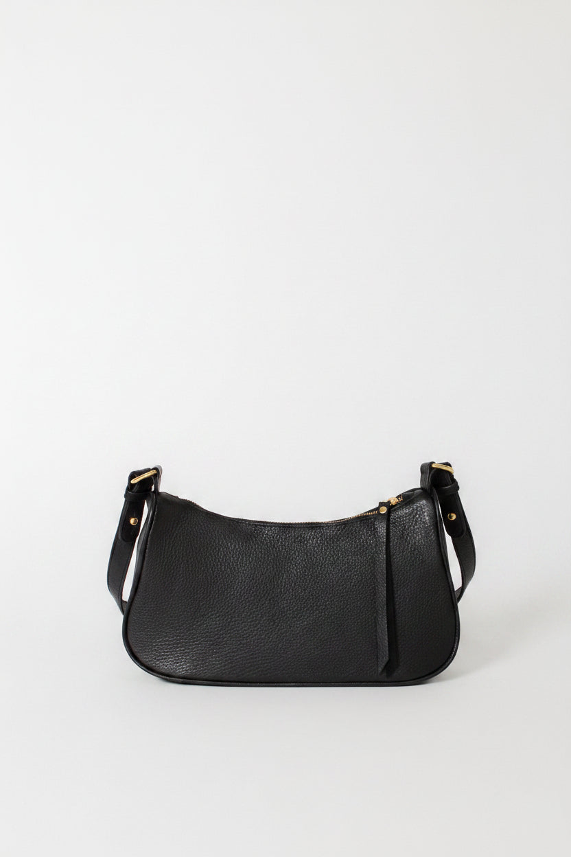 A petite black leather shoulder bag with solid brass hardware, displayed against a plain background.