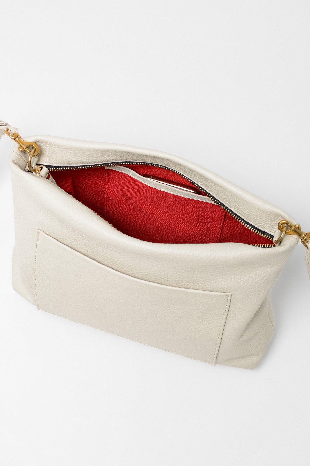 Off-white leather handbag with gold chain strap on a white background. This is the Gemma Crossbody.