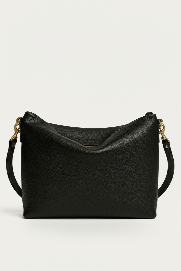 A black pebbled leather shoulder bag with gold-tone hardware and a thin black shoulder strap, shown against a plain light gray background.