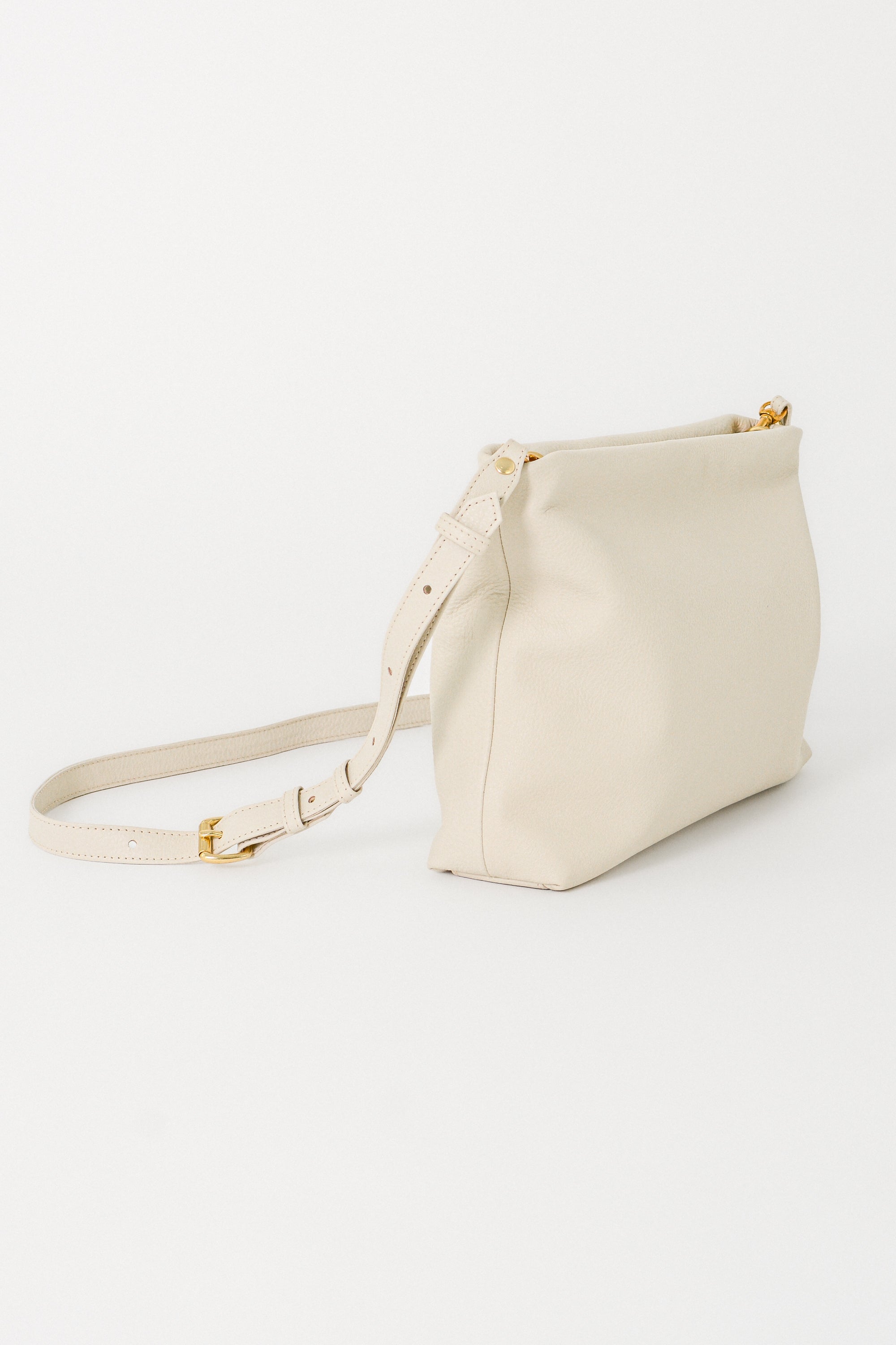 off-white handbag with a strap on a white background