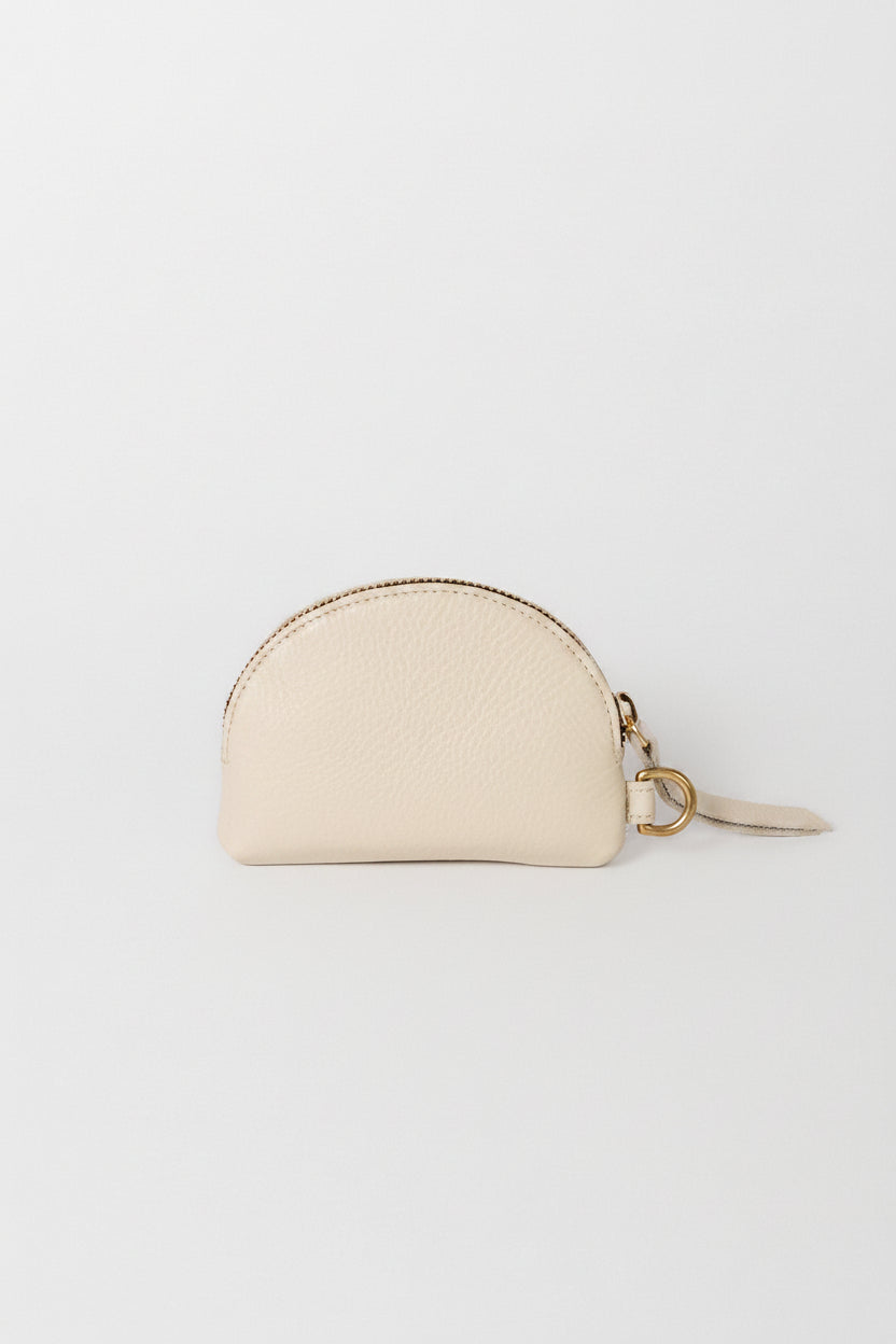 A small cream-colored leather pouch with a gold-tone zipper and a matching leather strap, shown against a plain light gray background.