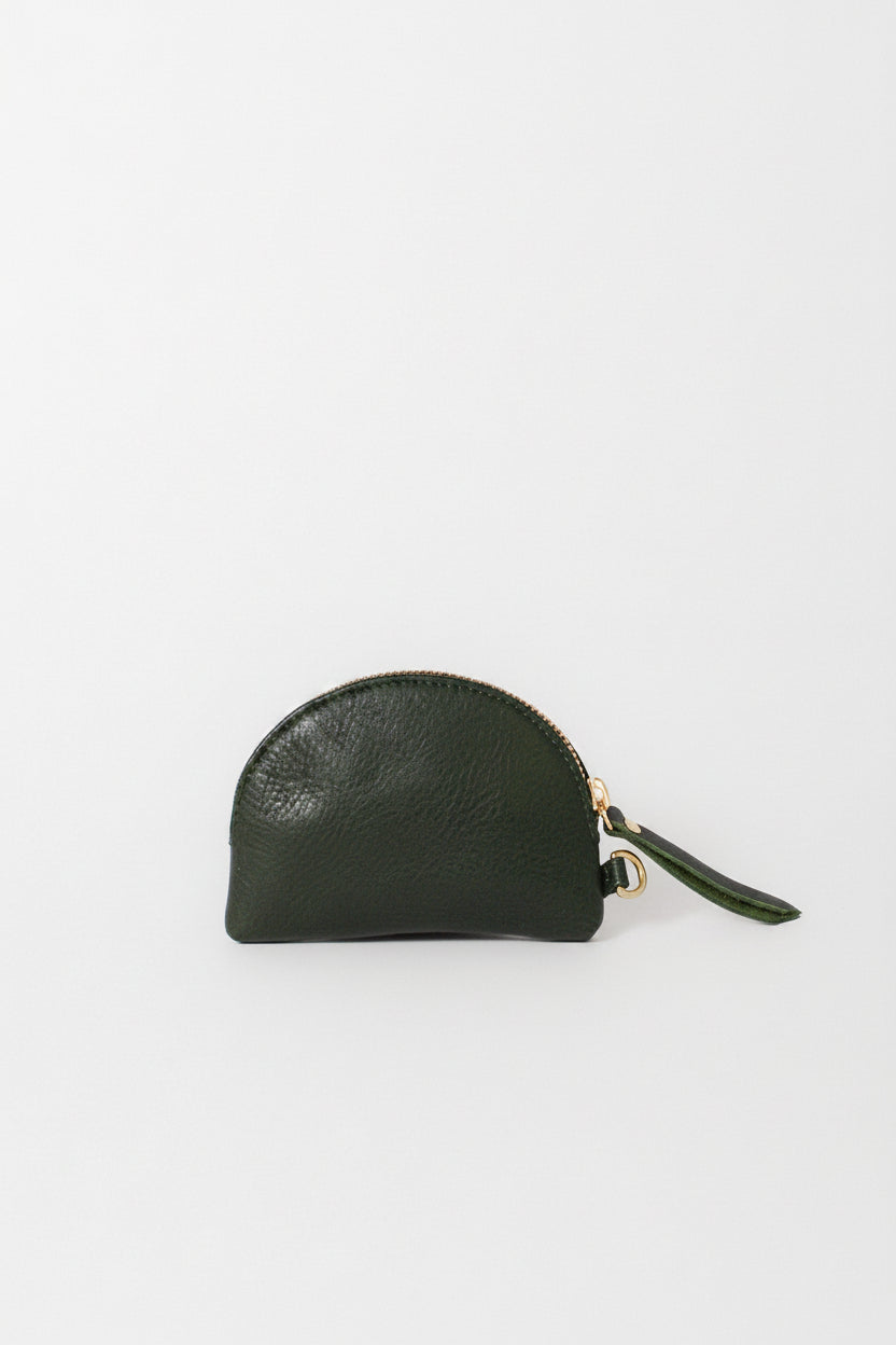 A small dark green leather zip pouch with a wrist strap and gold-tone hardware, photographed on a clean white background. This is the Half Moon Coin Purse.