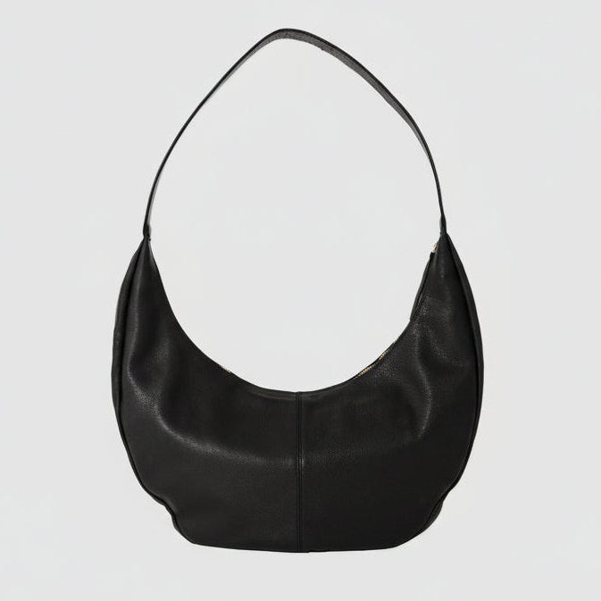 Half Moon Sling Bag in full-grain leather in black, solid brass hardware, by TAH handbags. 