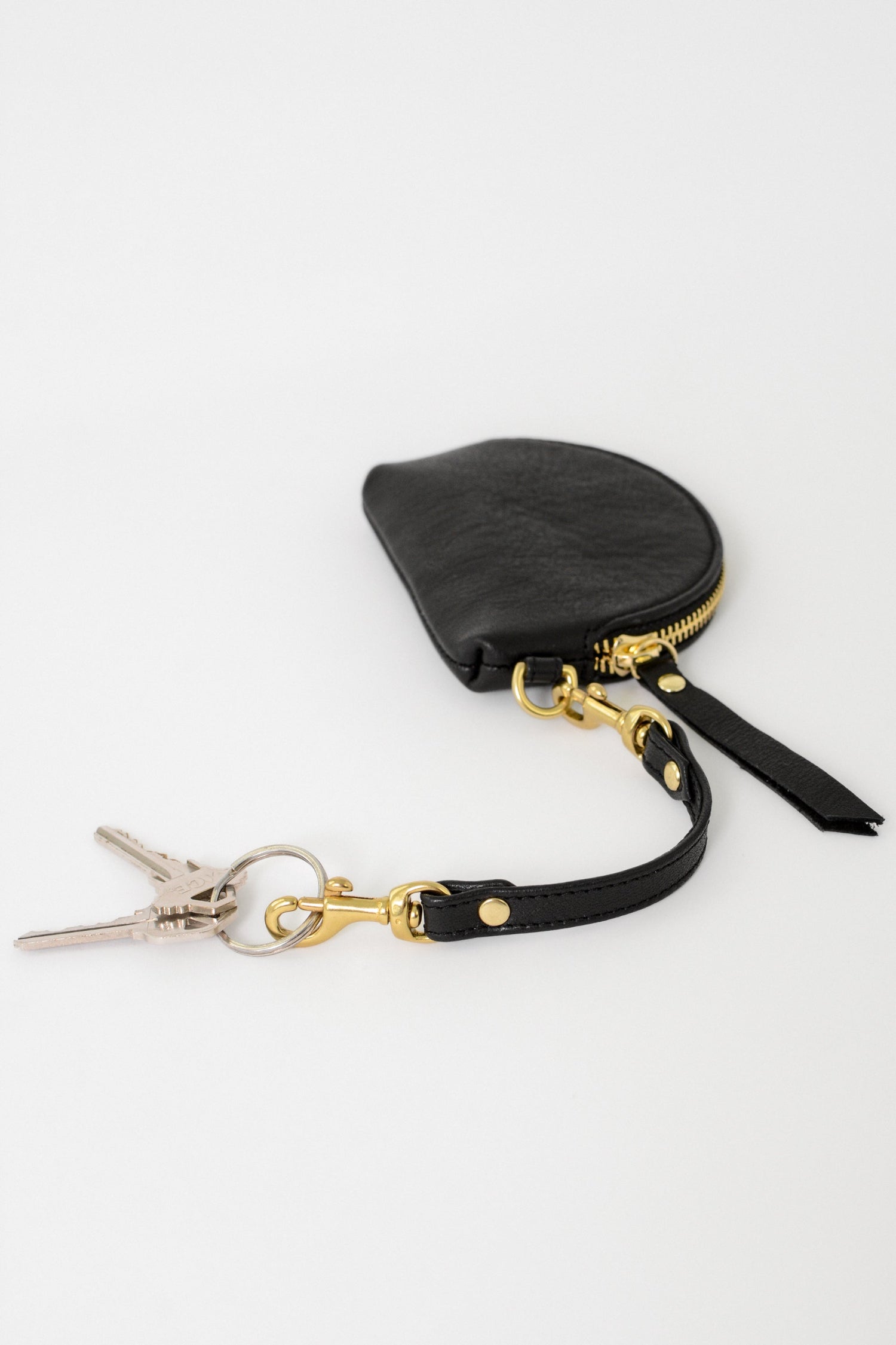 Black leather pouch with gold zipper and black leather key link with two gold clasps