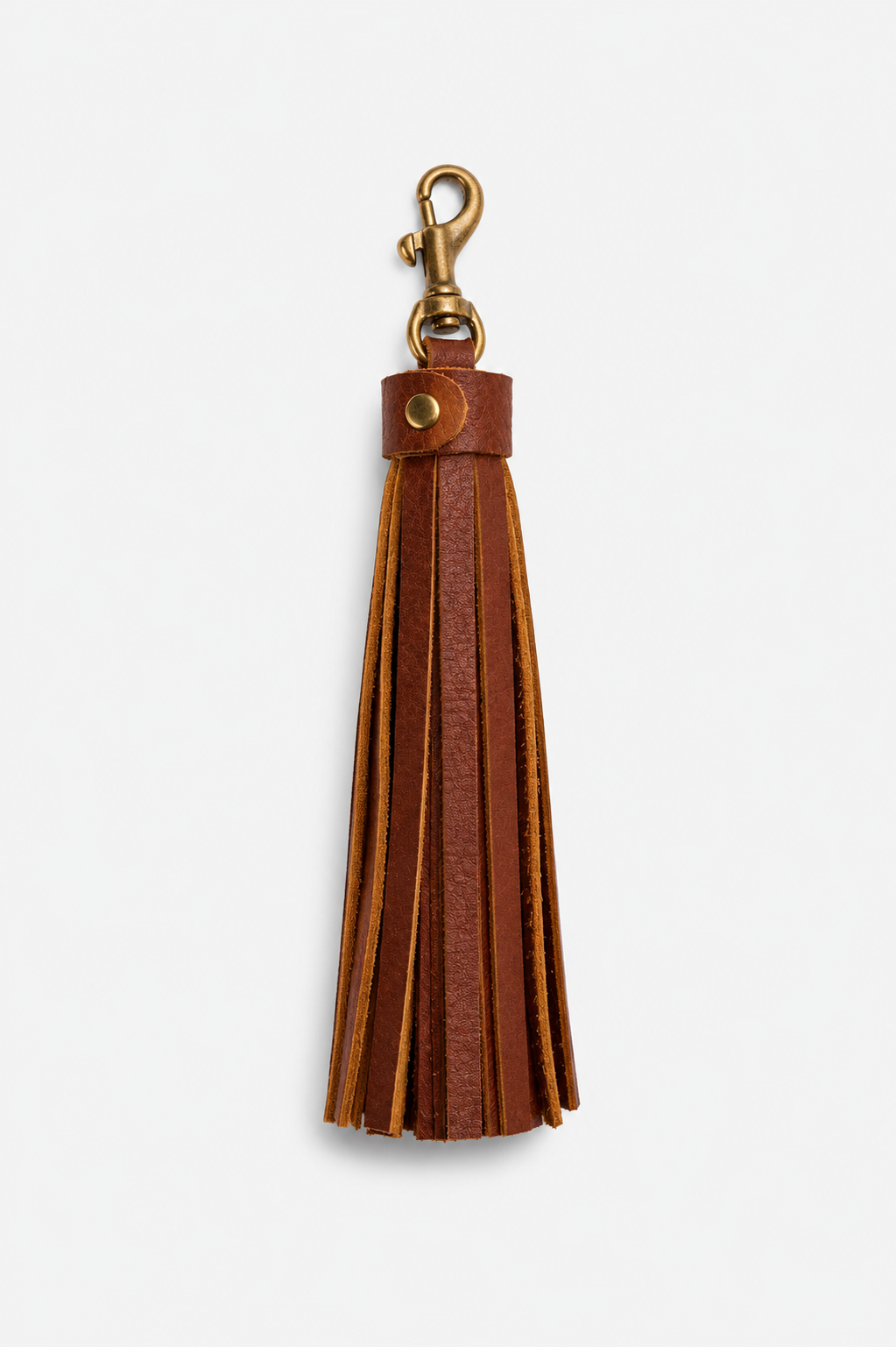 A brown leather tassel keychain with a brass clasp, shown against a plain light gray background.