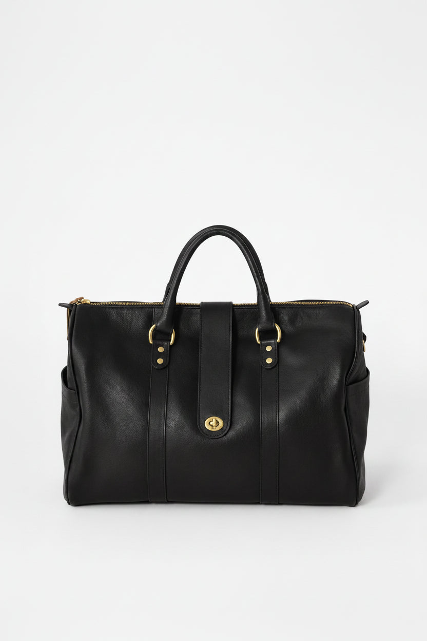 Loen Weekender Duffle in black leather with two handles and gold solid brass hardware. 