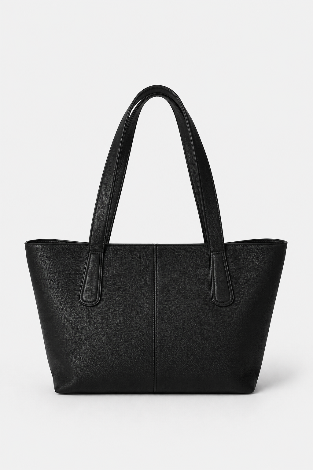 A black leather tote bag with dual shoulder straps, shown from the front against a light gray studio background. This is the TAH Megan Everyday Tote Bag.