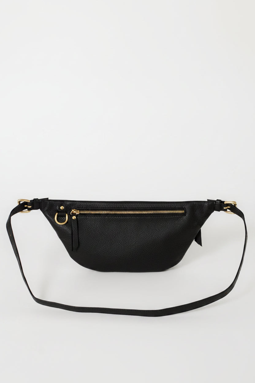 Black leather fanny pack belt bag back view, featuring an adjustable strap, rear zip pocket, and gold hardware, designed for secure storage and hands-free everyday use.