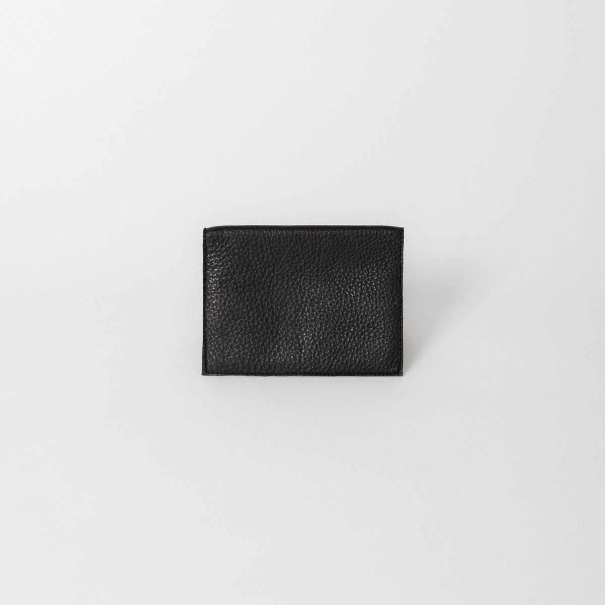 A full-grain leather travel wallet in black.