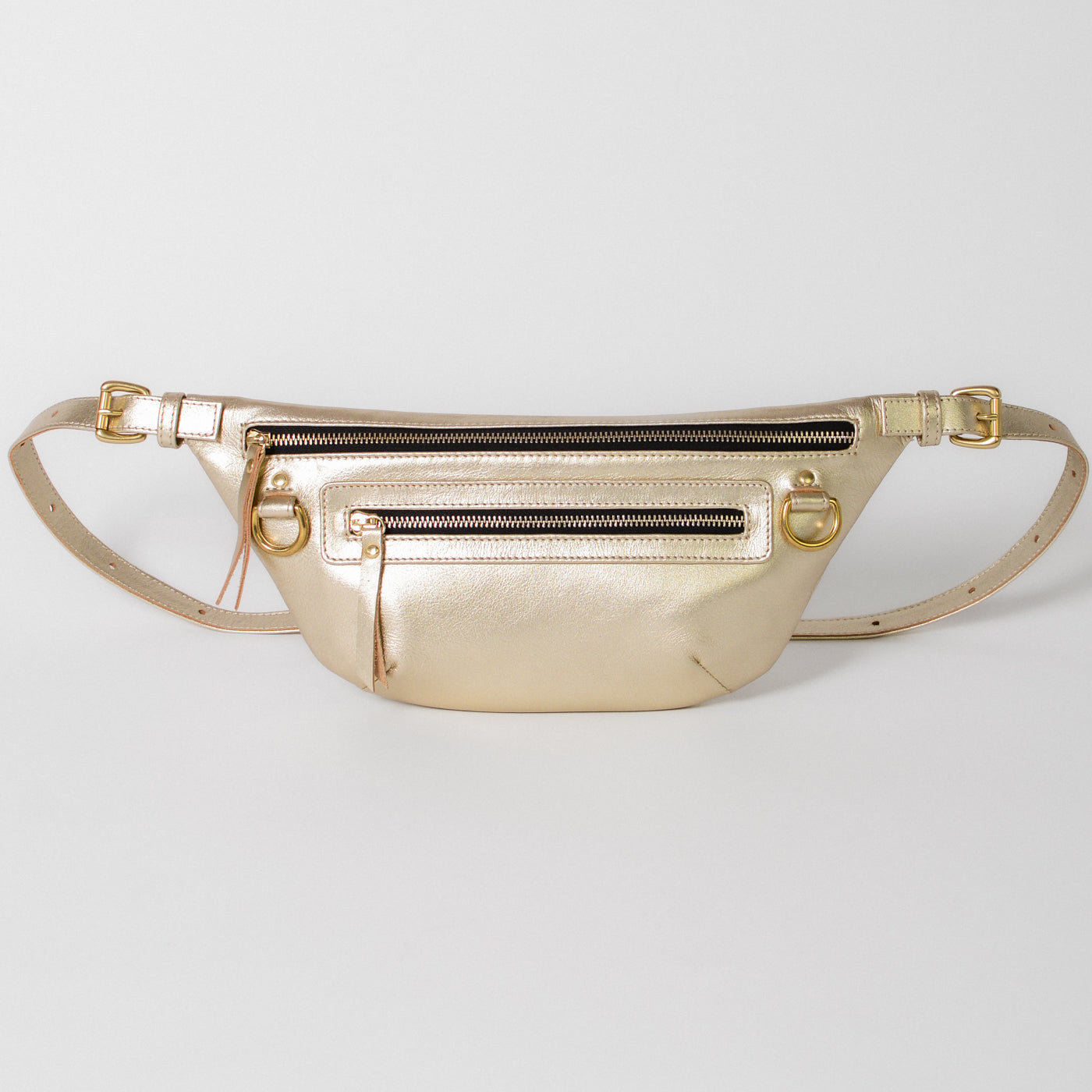 The Nomad Fanny Pack, handcrafted from full-grain leather with solid brass hardware. Features three exterior zipper compartments for organization, adjustable strap for versatile wear, and D-rings to attach keys or accessories. A modern, durable bag designed for everyday utility and travel.