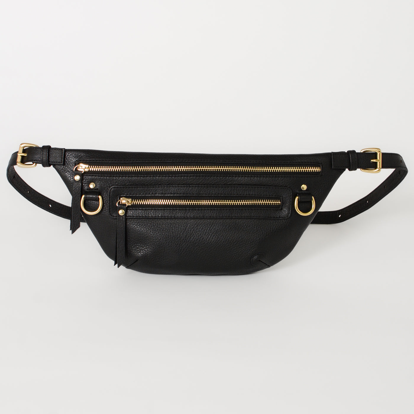 A black leather fanny pack with brass hardware and multiple zipper compartments, displayed against a white background.