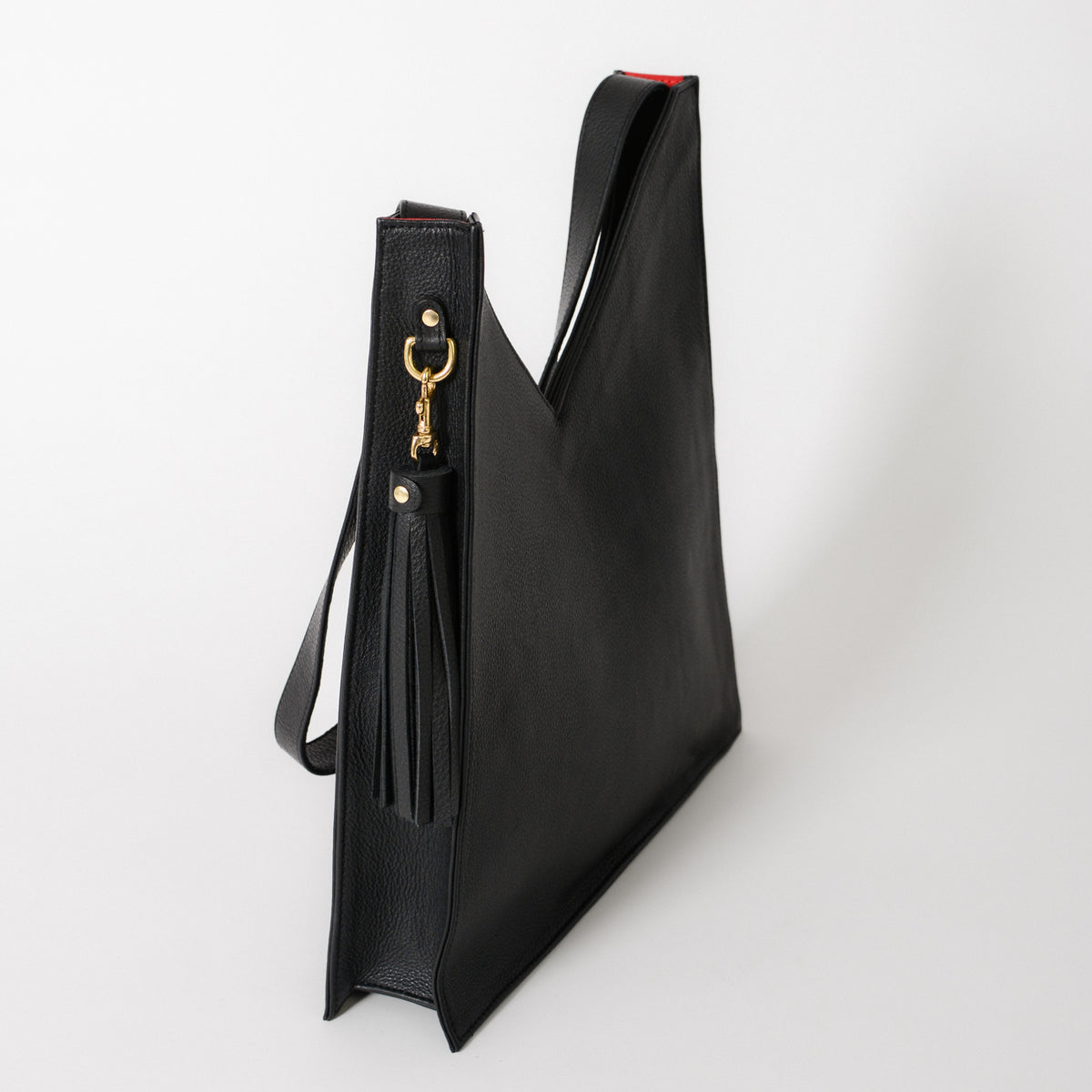Black leather tote bag with a v shape down the fromt.