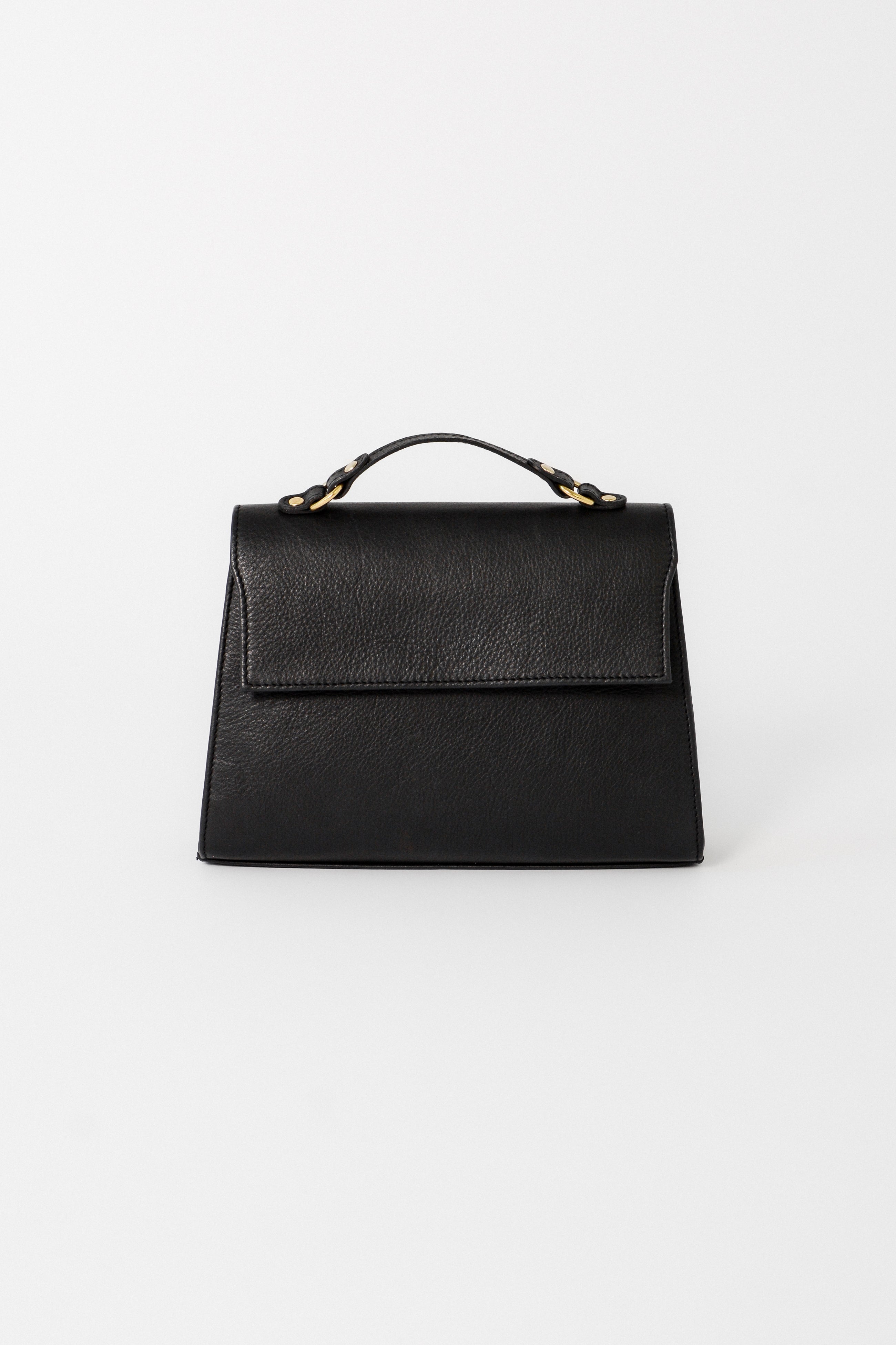Front view of the black leather Carrie Petite top-handle bag designed for evening wear, featuring a structured silhouette, flap closure, and refined gold hardware.