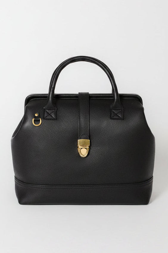 Front view of the Doctor Bag in black pebbled leather with structured top handles, gold hardware, and vintage-inspired clasp closure.