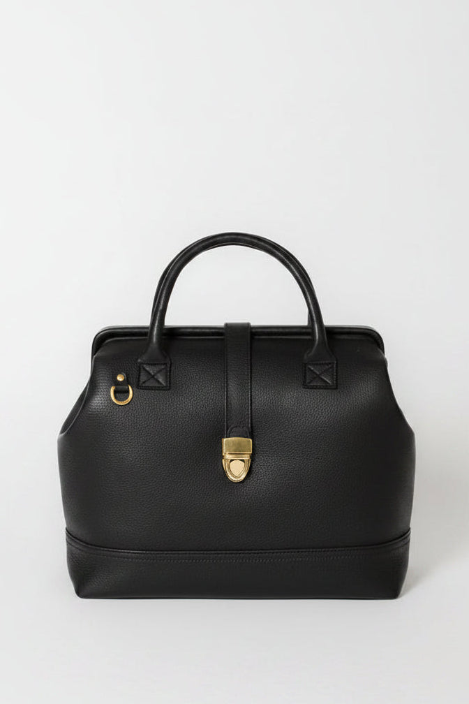 Front view of the Doctor Bag in black pebbled leather with structured top handles, gold hardware, and vintage-inspired clasp closure.