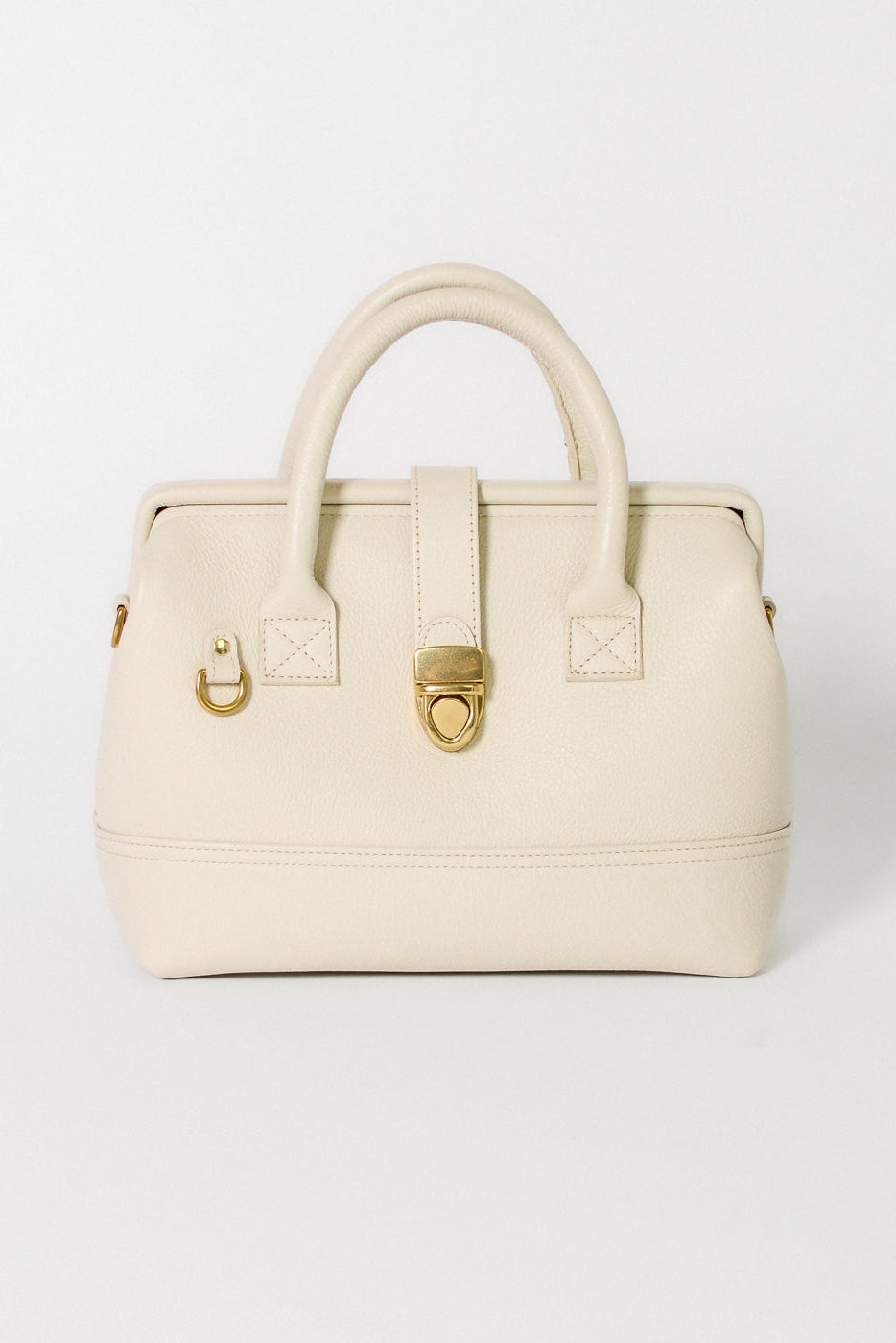 Front view of the Doctor Bag in ivory leather, featuring structured top handles, a signature gold lock closure, and a clean, architectural silhouette.