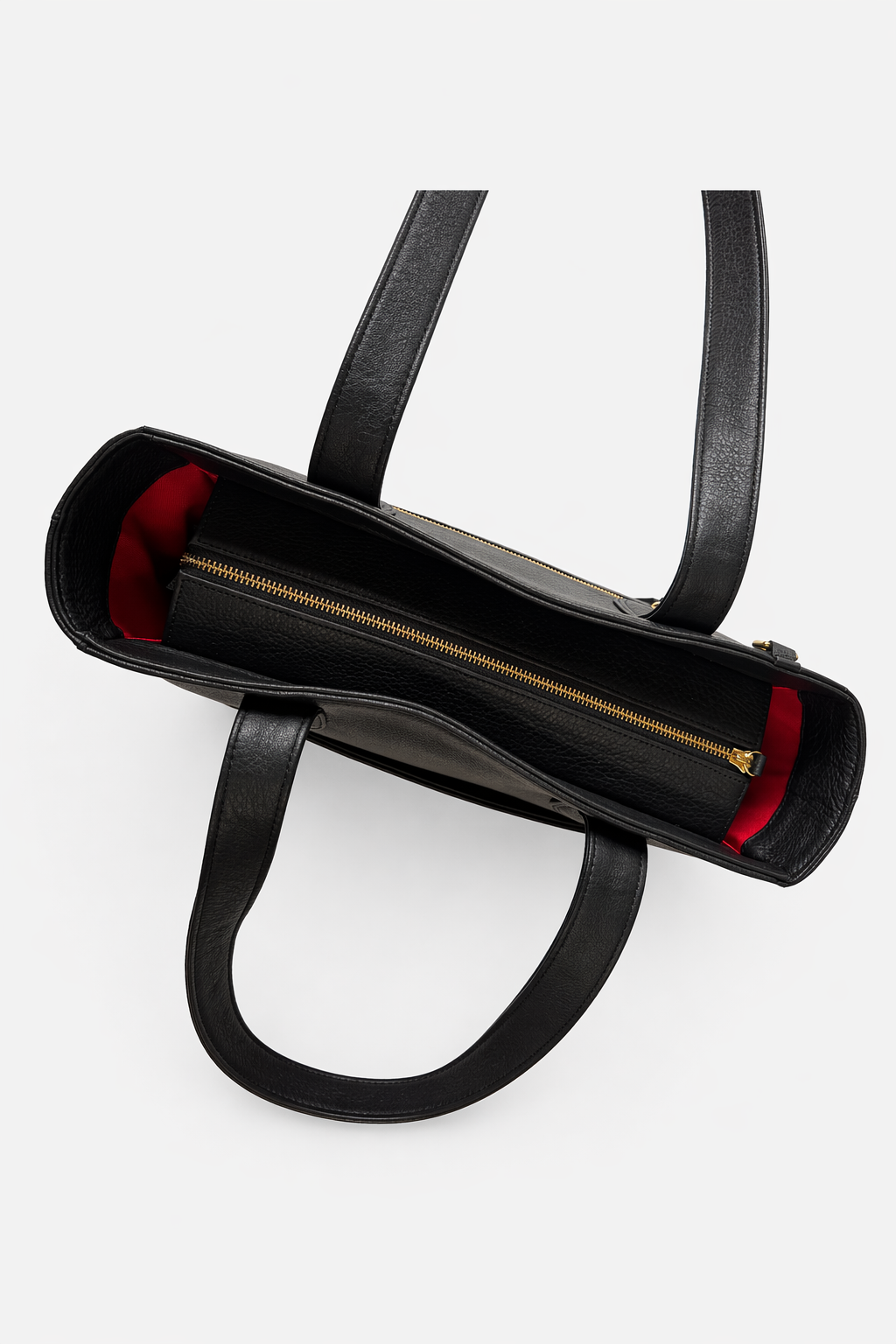 Top view of the Emily Tote in black leather featuring a full-length zipper closure and structured interior with signature red lining.