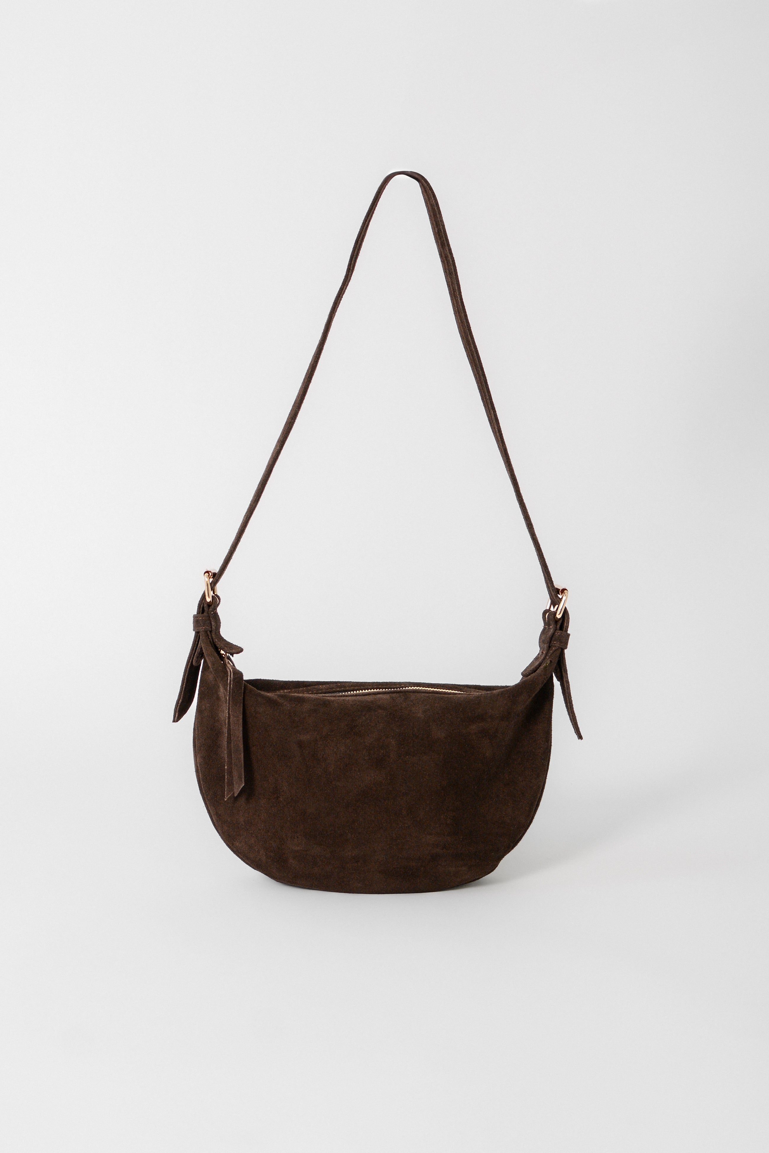 Brown suede Nova Sling Bag with adjustable strap, a soft structured crossbody designed for everyday wear and casual styling.