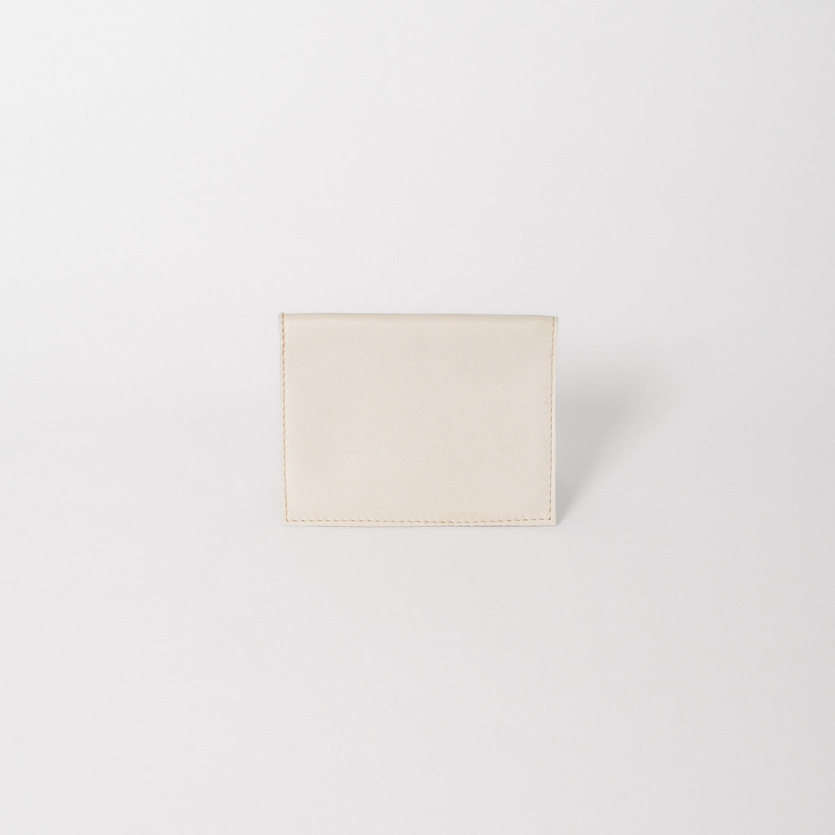 A leather passport wallet in the color bone