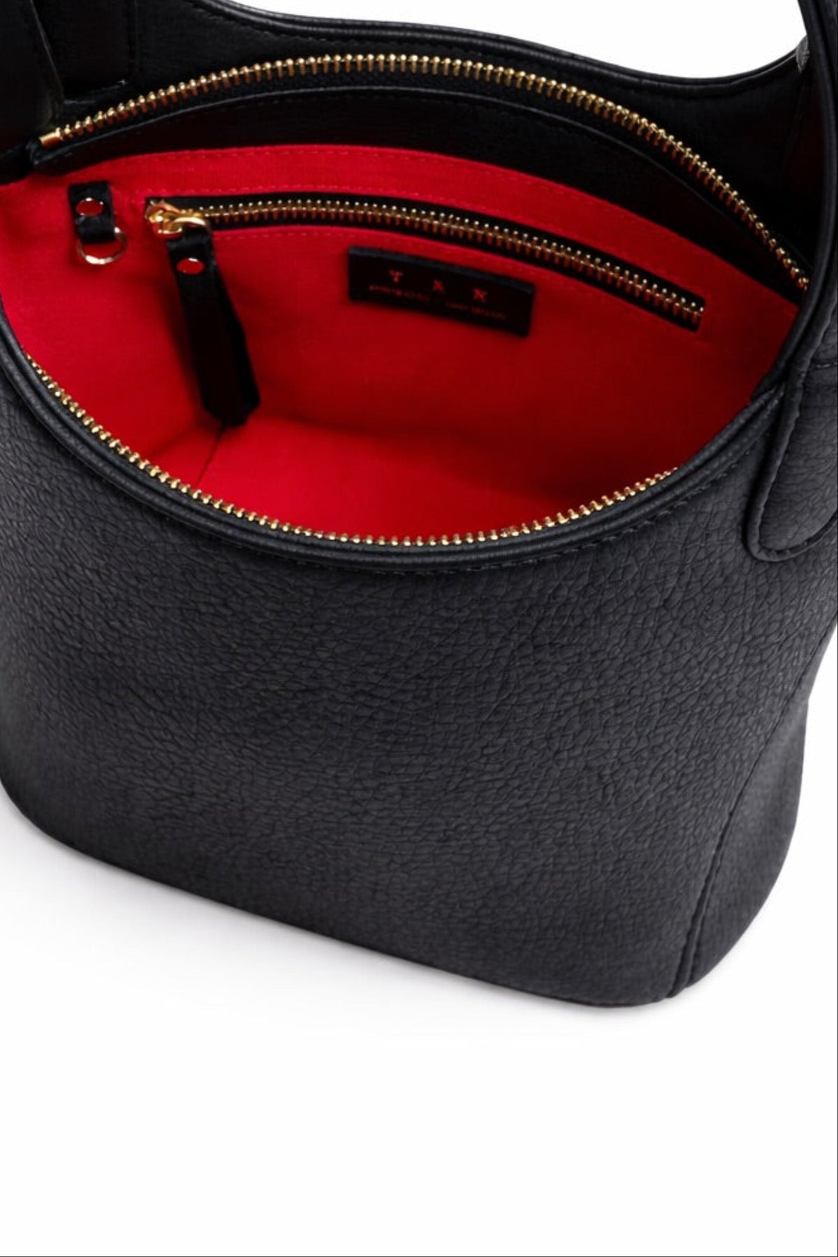 Interior of black leather Phoebe bucket bag showing red lining, interior zip pocket, and structured opening with gold hardware and a dring to attach your keys