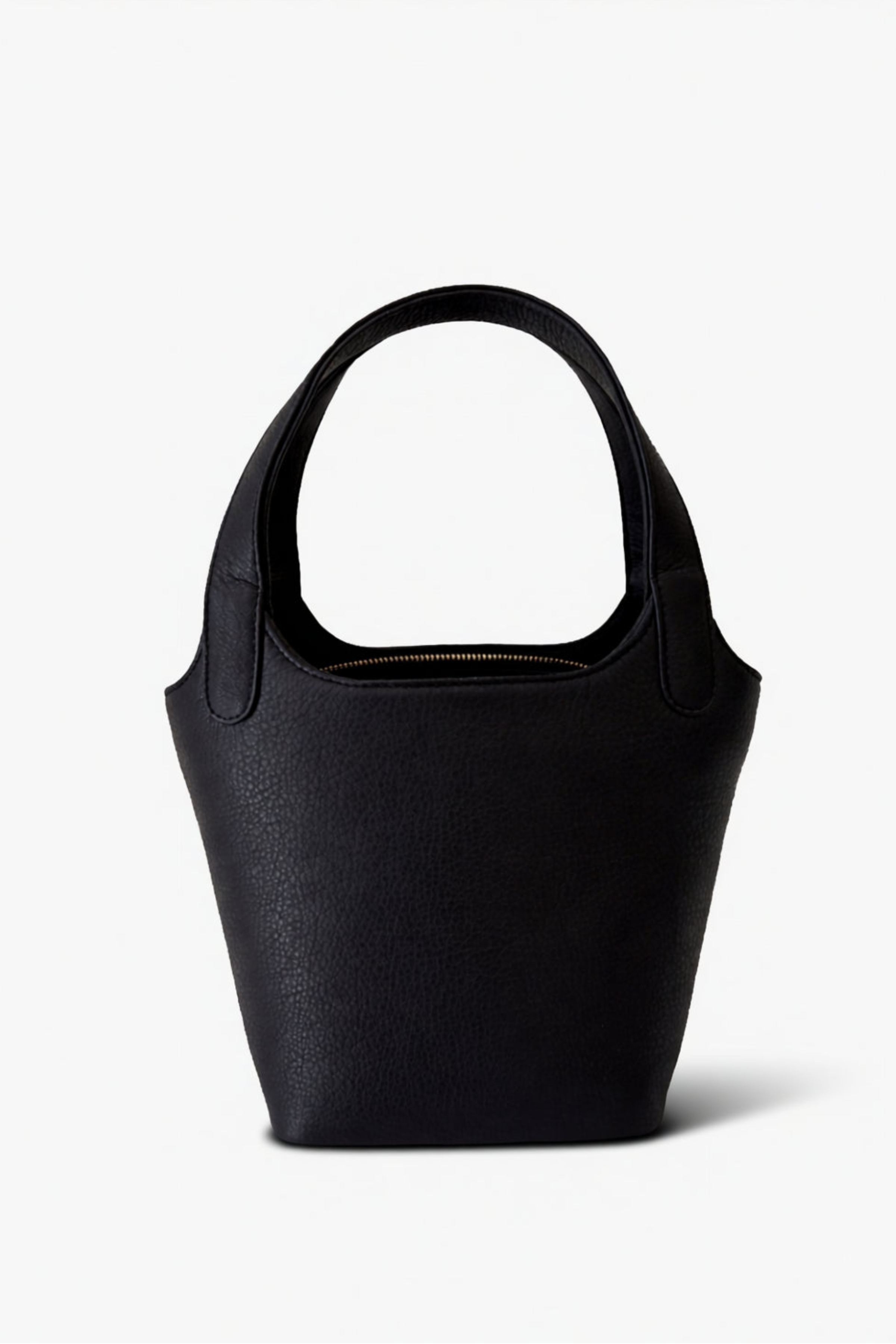 Black leather Phoebe bucket bag with structured silhouette and top handle, featuring a clean, minimalist design for everyday carry.