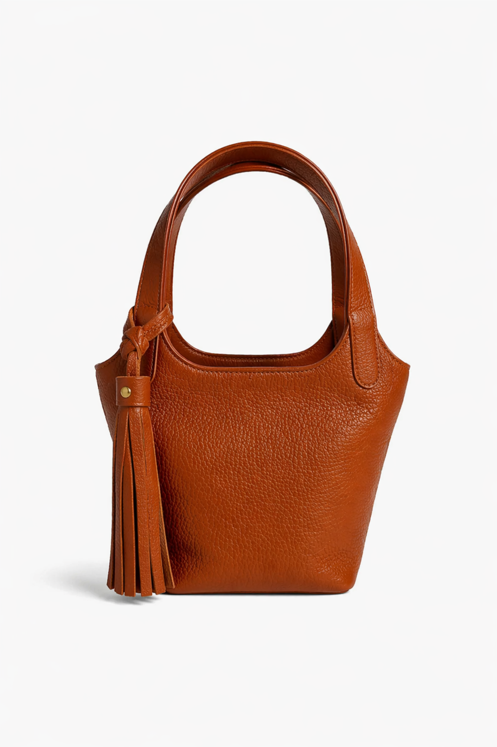 Cognac leather Phoebe bucket bag with top handle and tassel detail, featuring a structured silhouette and minimalist design for everyday use.