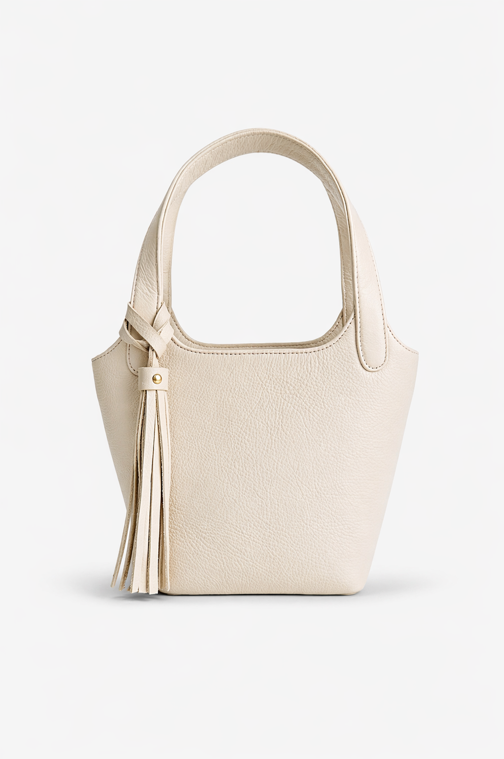Ivory leather Phoebe bucket bag with top handle and tassel detail, featuring a soft structured silhouette and clean, minimalist design.