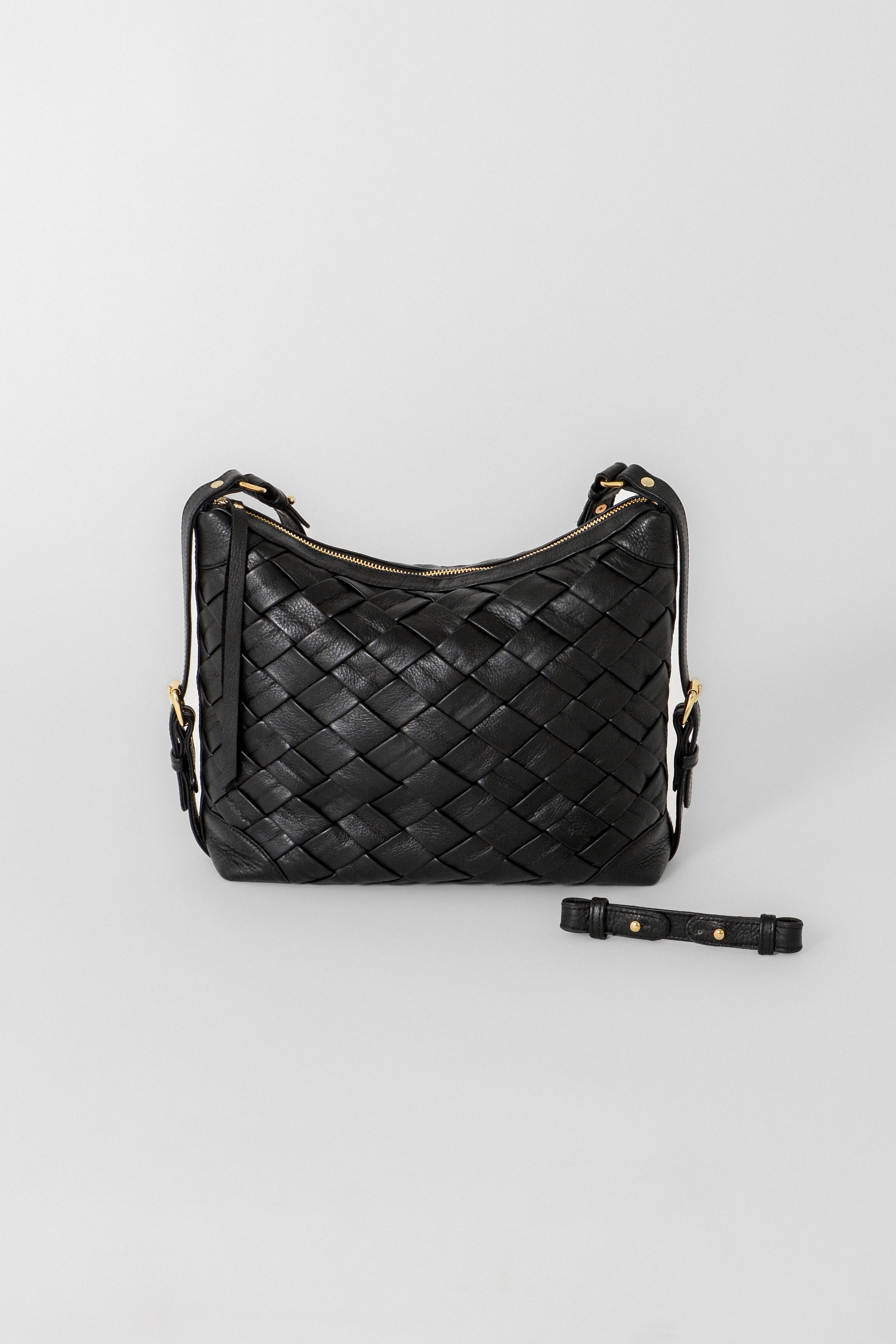 Front view of the Selena Handwoven black leather bag with woven detailing, shown with the removable shorter strap placed alongside for versatile styling options.